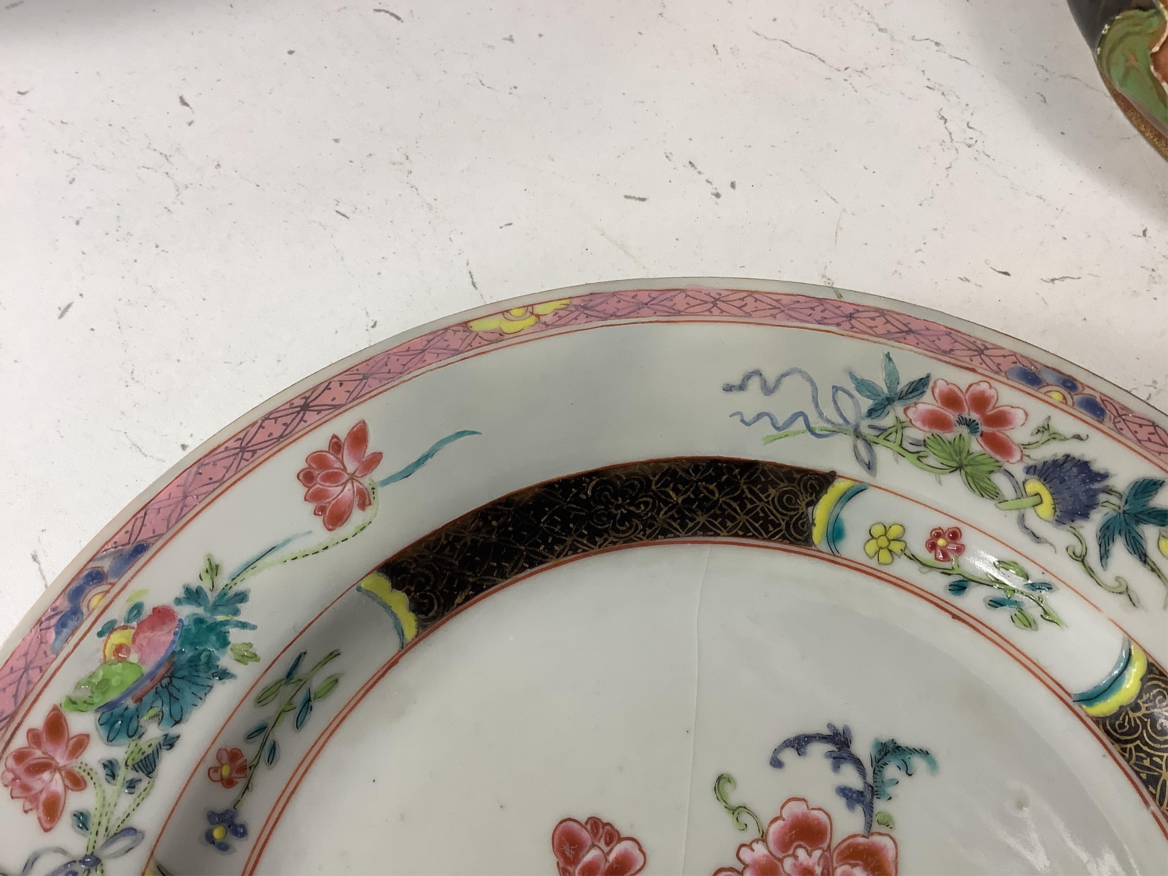 A Chinese iron-red ‘sanduo’ dish, 19th century and a Chinese famille rose plate, Yongzheng. famille rose plate 22.5cm diameter. Condition - poor to fair